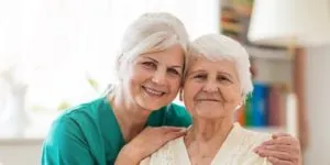 Home caregiver and senior adult woman