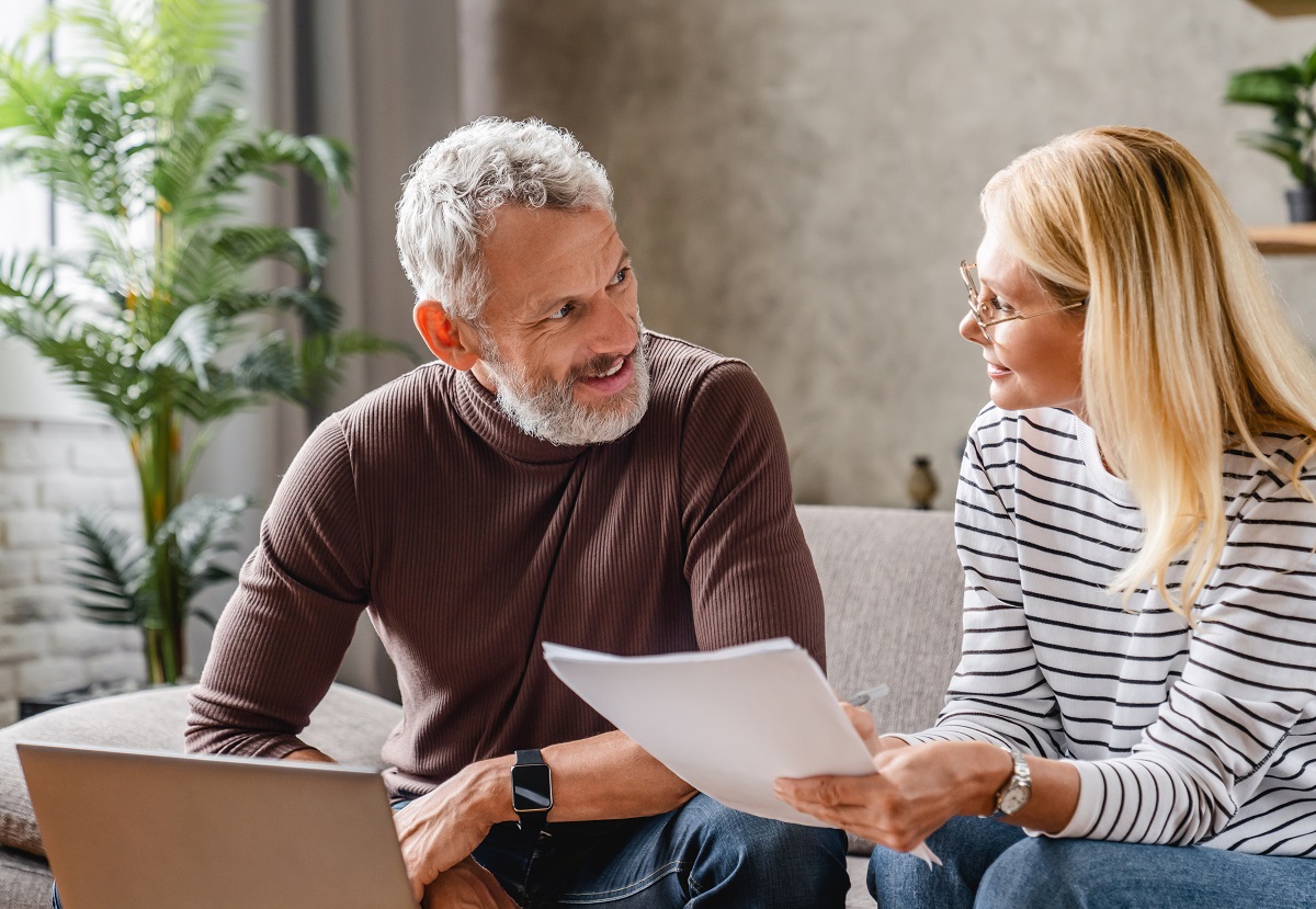 Smiling couple working on financial planning in their home