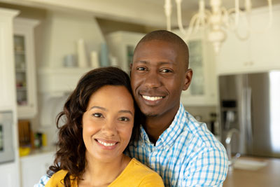 Grandfather and granddaughter outdoors smiling and laughing
