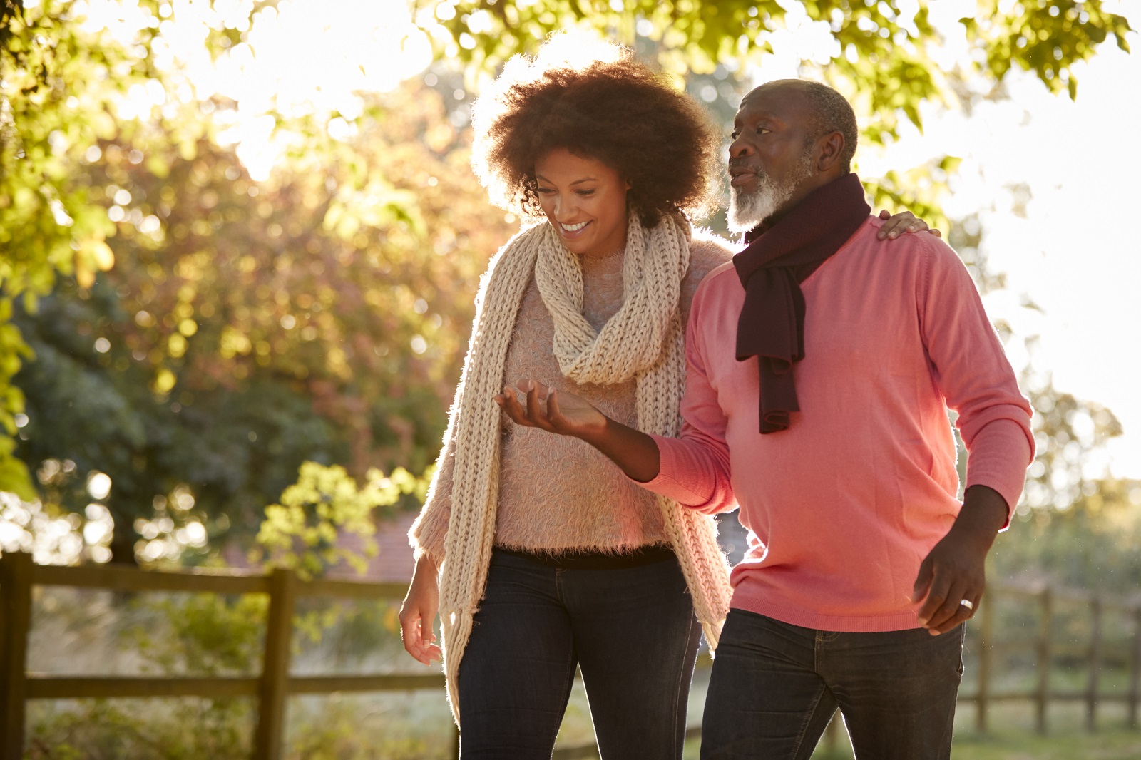 Senior Father With Adult Daughter Enjoying Autumn Walk