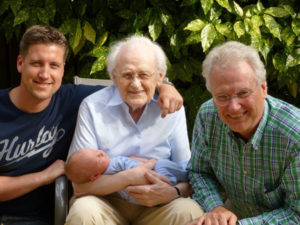3 generations of men, grandfather-father-son, sitting and enjoying each others company