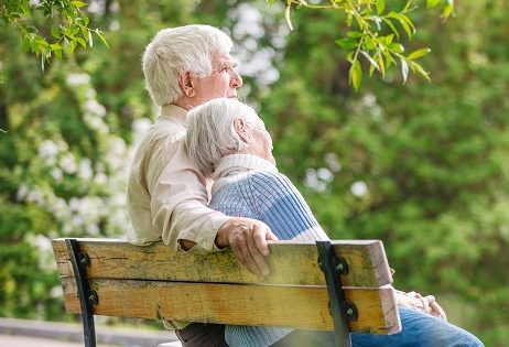 Senior couple resting on a bench in the park